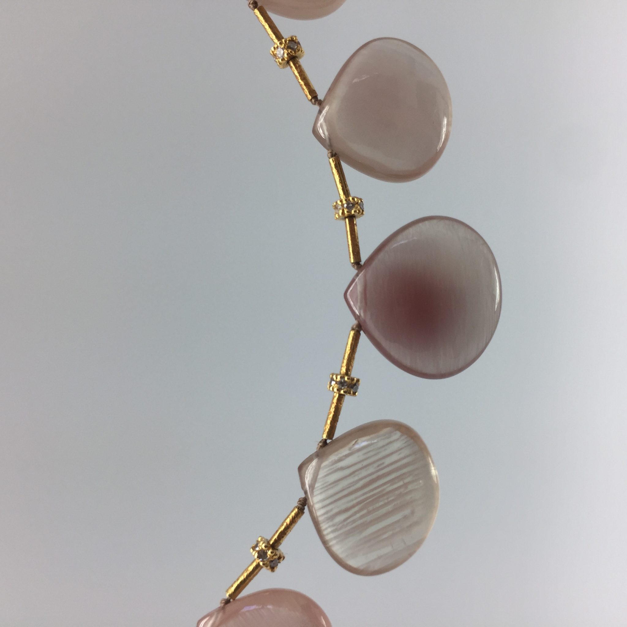 Daydreaming in Sunstones: Sunstone necklace of opaque smooth clam-shaped briolettes spaced with 18K gold tubes and 14K rondelle beads studded with diamonds. Item N00006 detail photo 02 closeup of stones