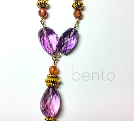 Closeup photo of amethyst necklace with high karat gold antiques beads