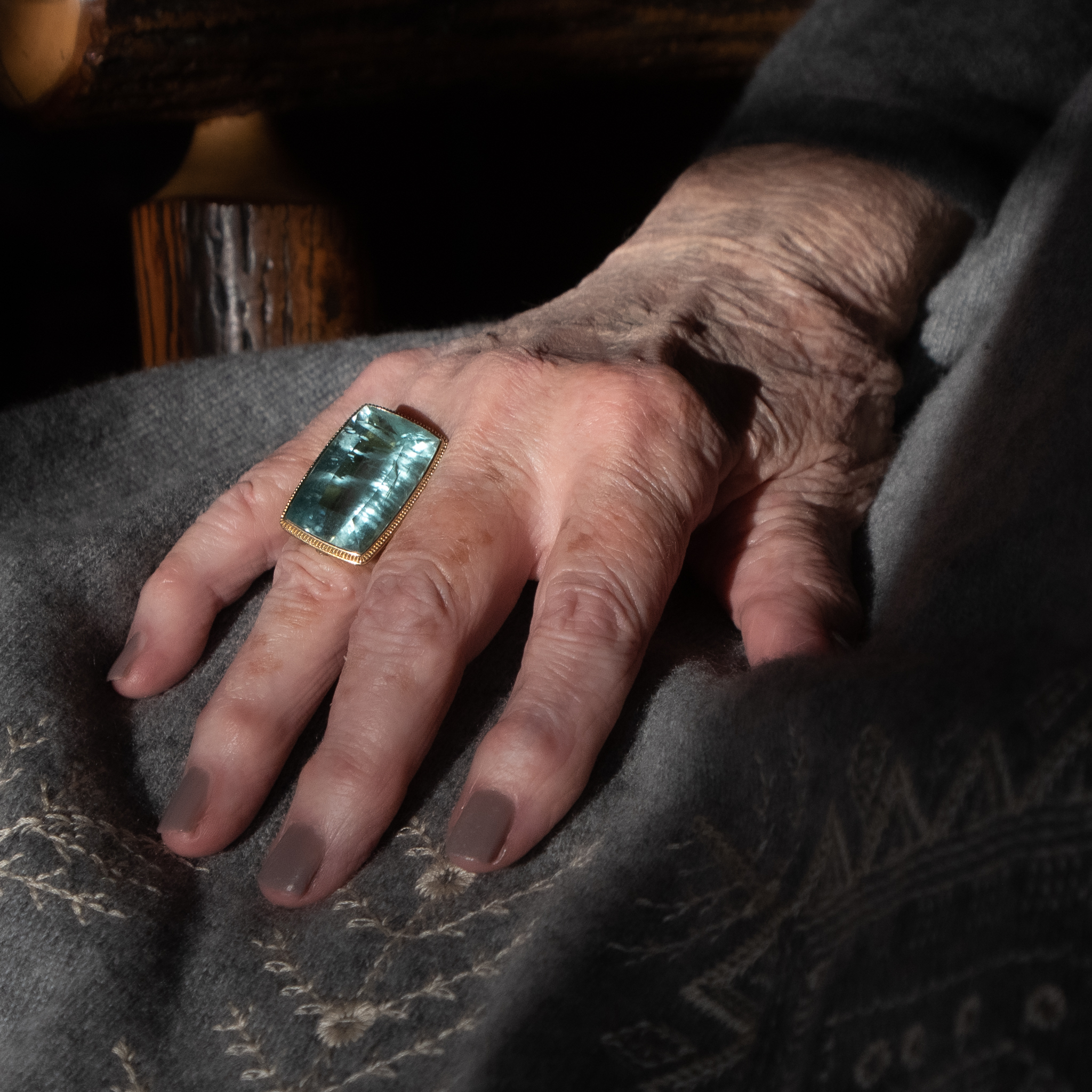 35 carat aquamarine cocktail ring on the hand of an older woman, showing incredible color and jardinère