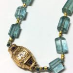 detail of antique 18K gold enameled clasp on aquamarine crystal necklace
