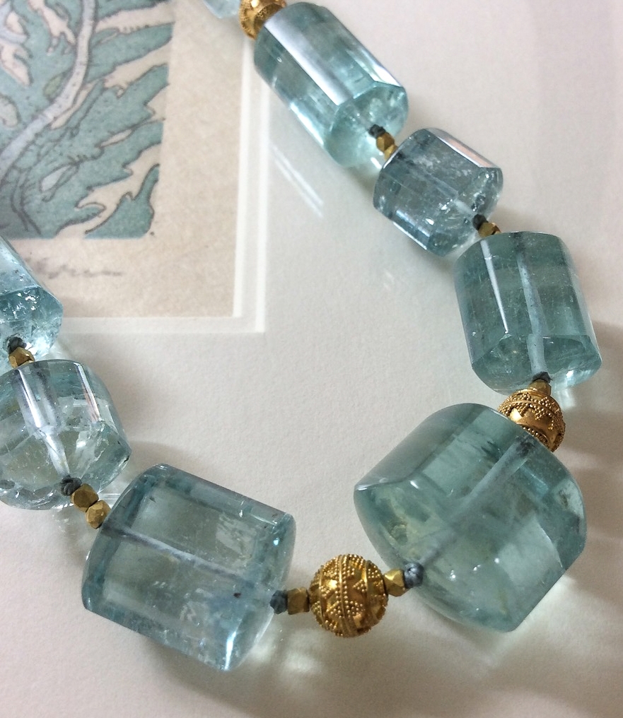 close-up photograph of polished aquamarine crystals with Bali 20K gold granulated beads