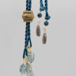 dressmaker details on this aquamarine crystal necklace showing silk cords, pearl loops and tassel detail