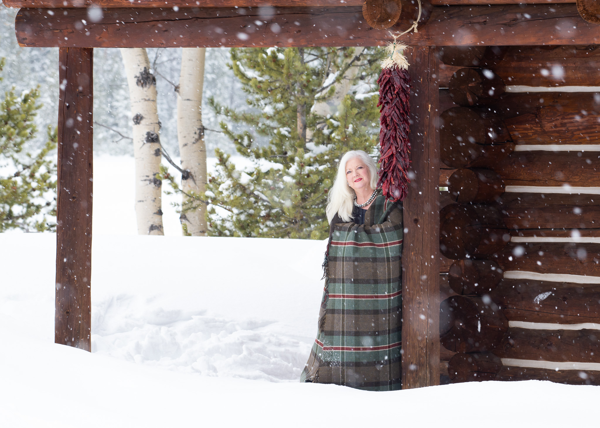 Atelier bento jewellery designer Carolyn B. Pitts in the wintery Colorado high country, modeling a double strand of Tahitian pearls