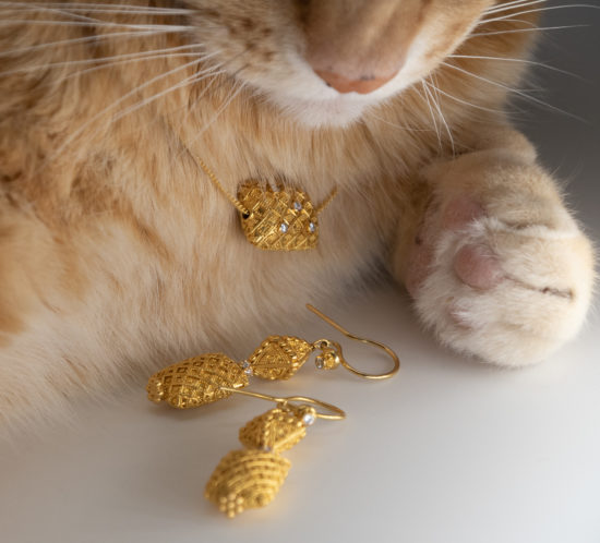Closeup of Bali 20K gold fancy granulation earrings and matching pendant