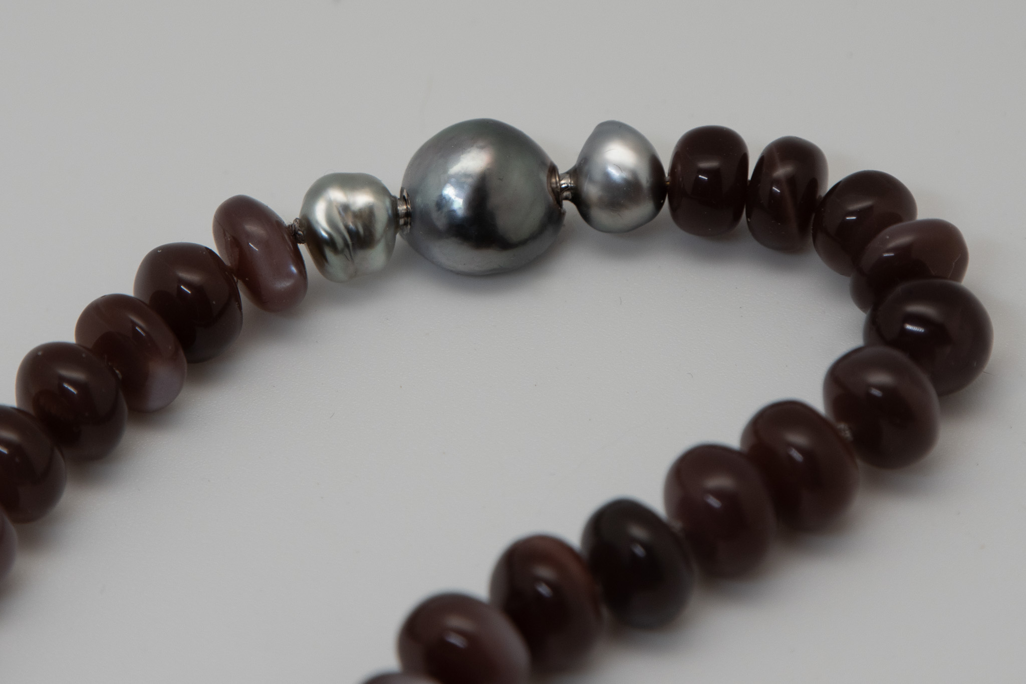 Chocolate moonstone necklace showing clasp detail of 13mm Tahitian pearl tube and key clasp flanked by gray Tahitian Keshi pearls
