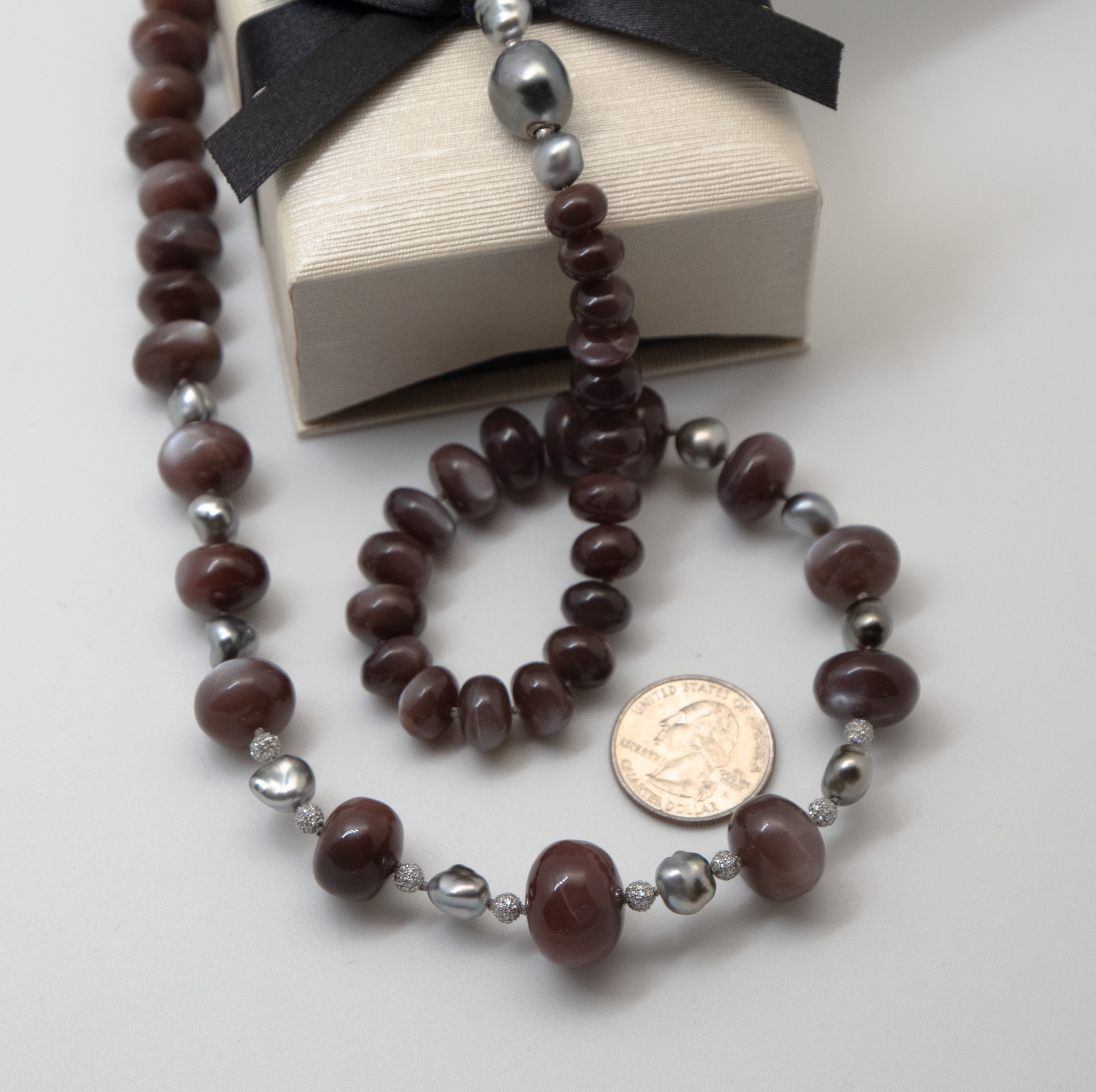 chocolate moonstone necklace showing US quarter can for scale