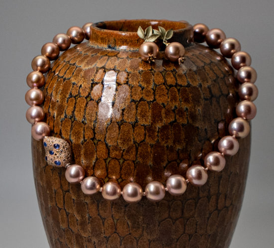 Edison pearl necklace with fancy clasp shown on a vintage Jorge Wilmot vase