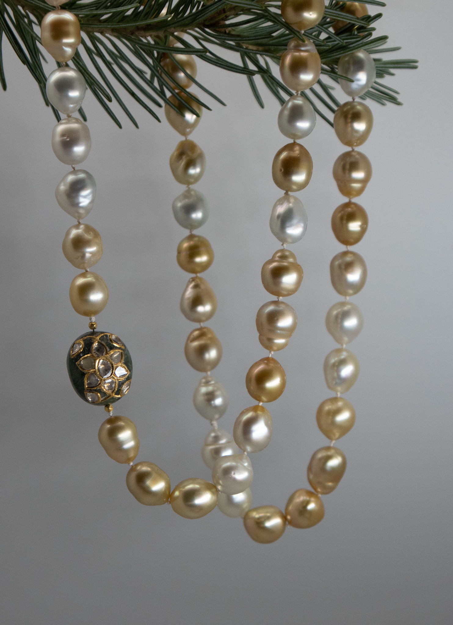 Closeup of Philippine Golden South Sea Pearls with Emerald bead clasp