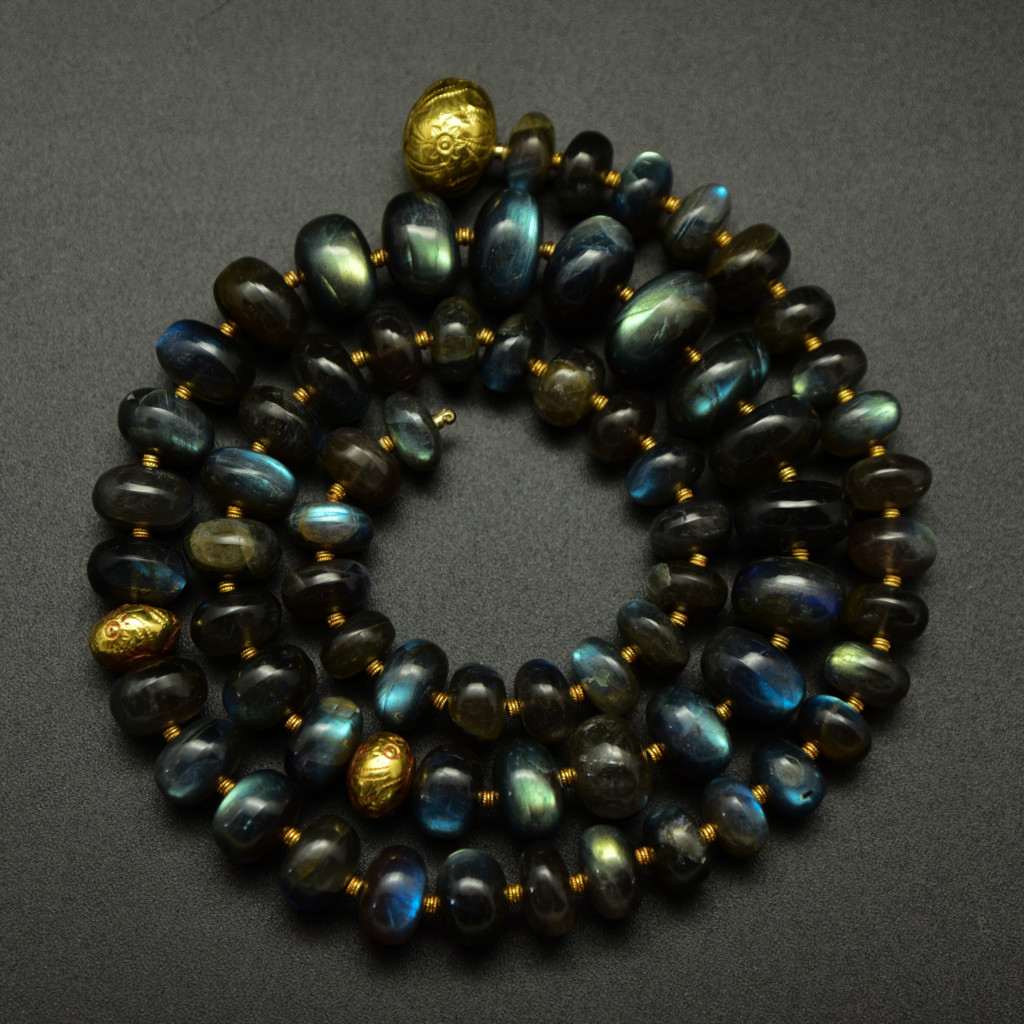 labradorite necklace with 18k gold spacers coiled up to show off the stones