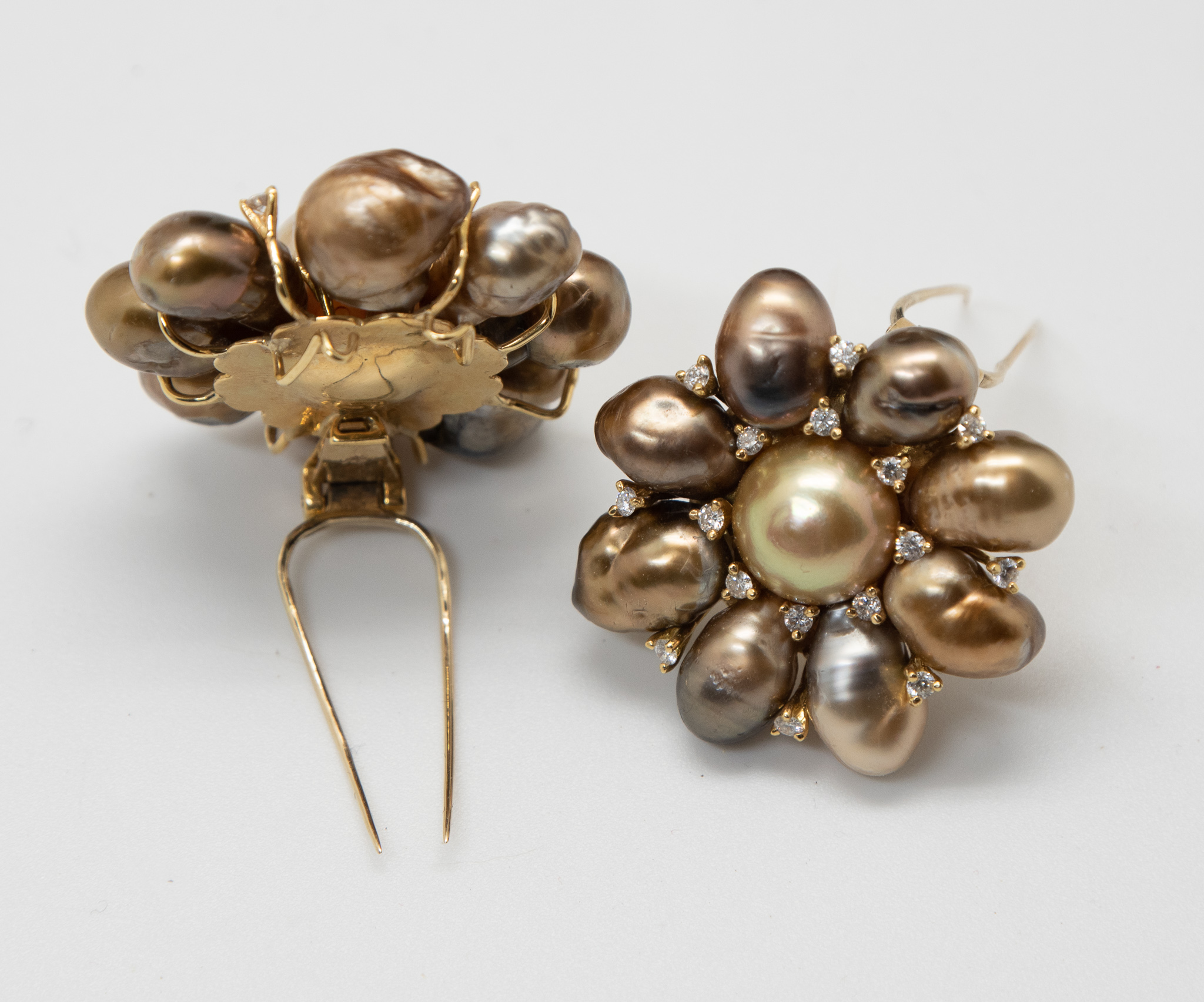 A pair of Tahitian pearl and diamond brooches showing one from the front and one from the back