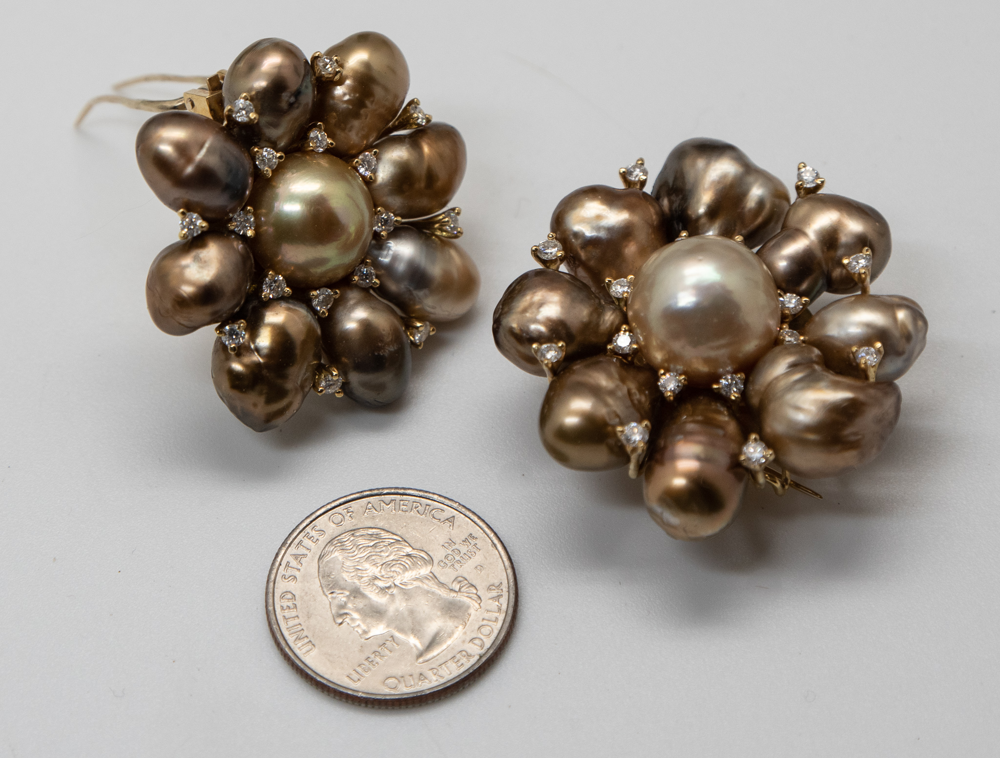 Two Tahitian pearl and diamond brooches shown US quarter coin for scale. Brooches 2 inches in diameter and 1.75 inches in diameter respectivly.