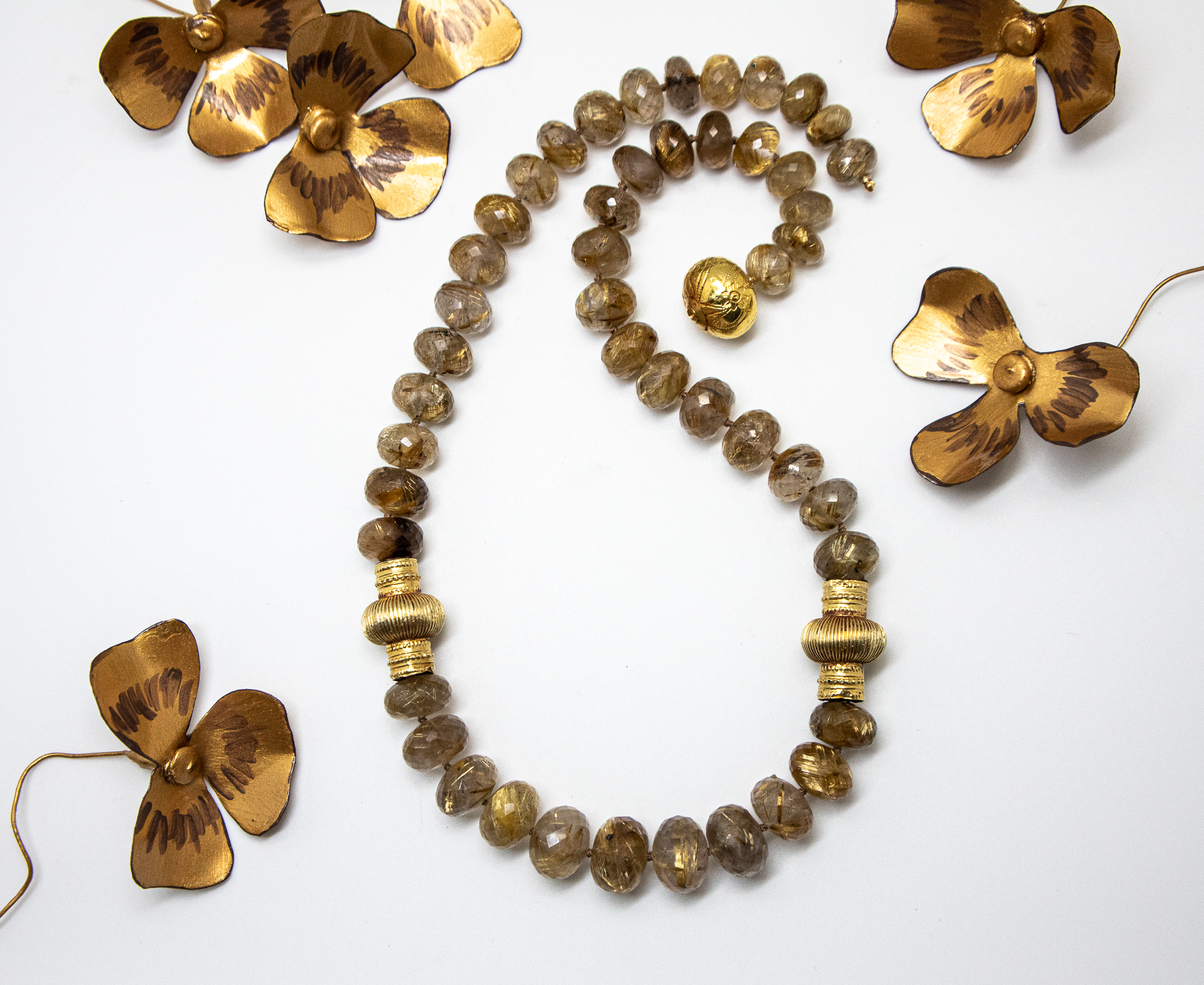 Rutilated Quartz bead necklace shown with metal flowers