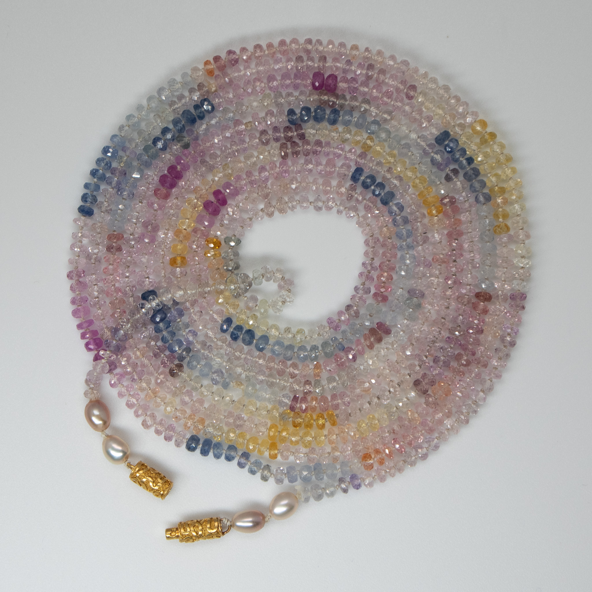 multi color tiny faceted sapphires coiled to show color transitions