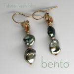 Close up of Tahitian Keshi pearl, 18K gold and diamond bead earrings