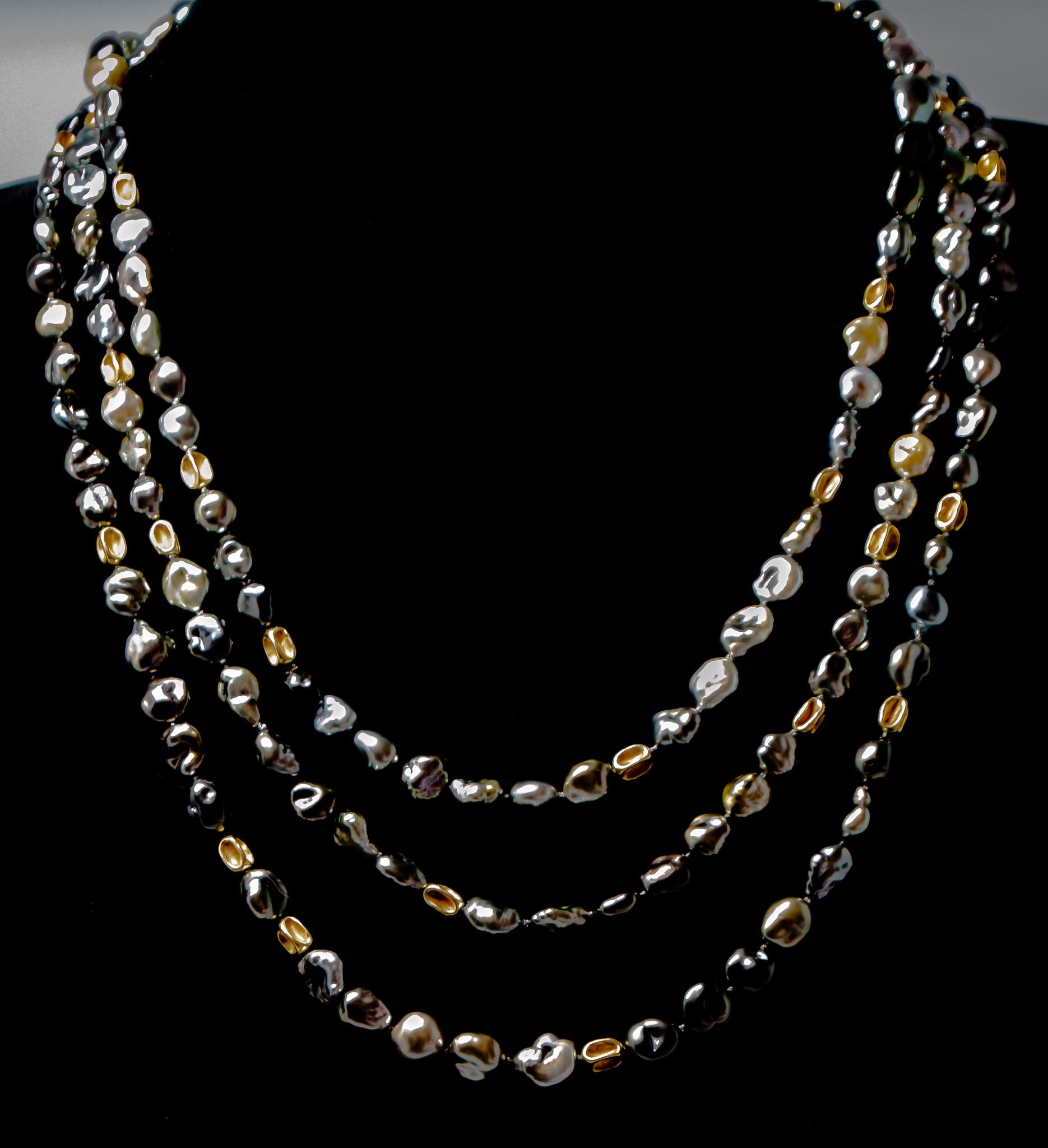 Eighty-five inches of Tahitian pearl bliss - Keshi pearls with 18K gold accent beads shown wrapped three times for a princess-length look