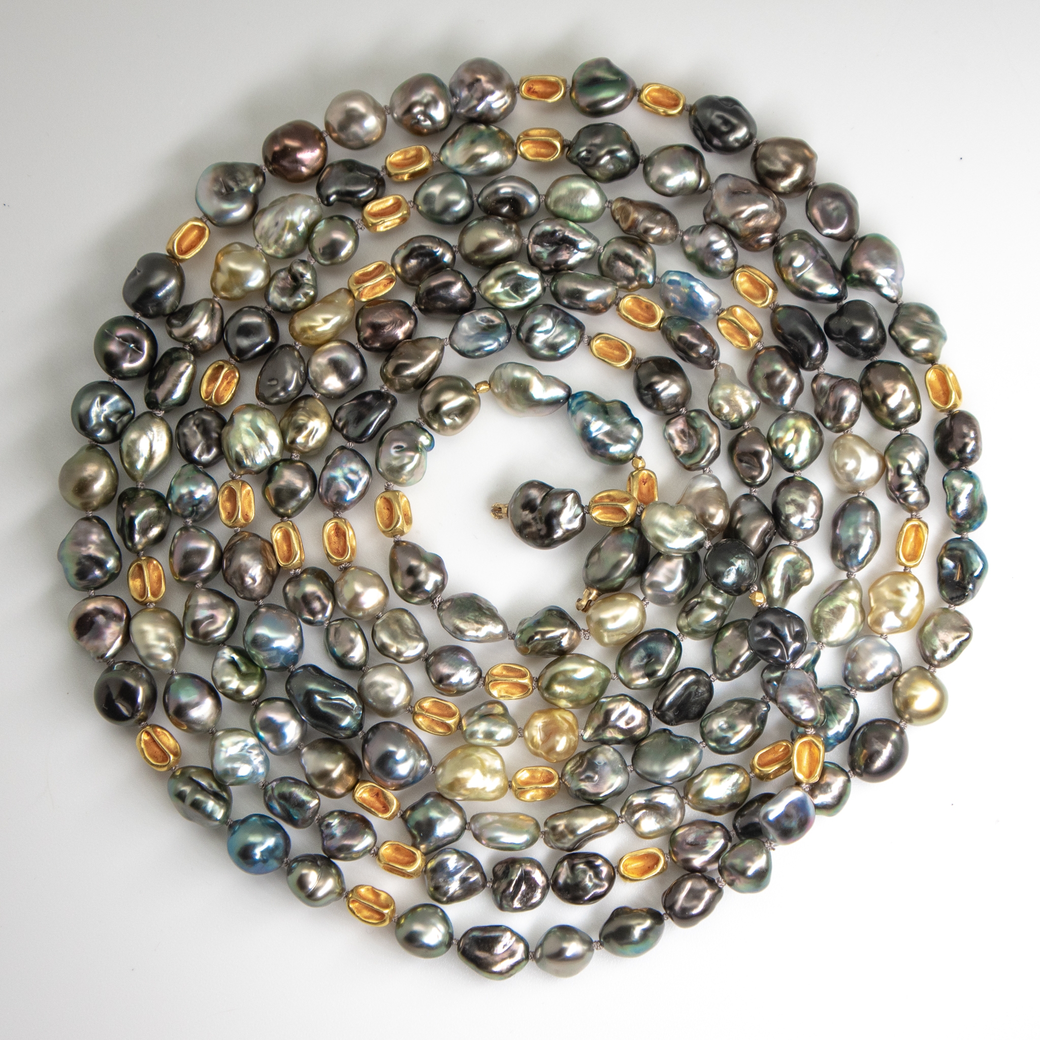 coiled 72 inch long Tahitian Keshi pearl & gold necklace showing multicolors and fine lustre