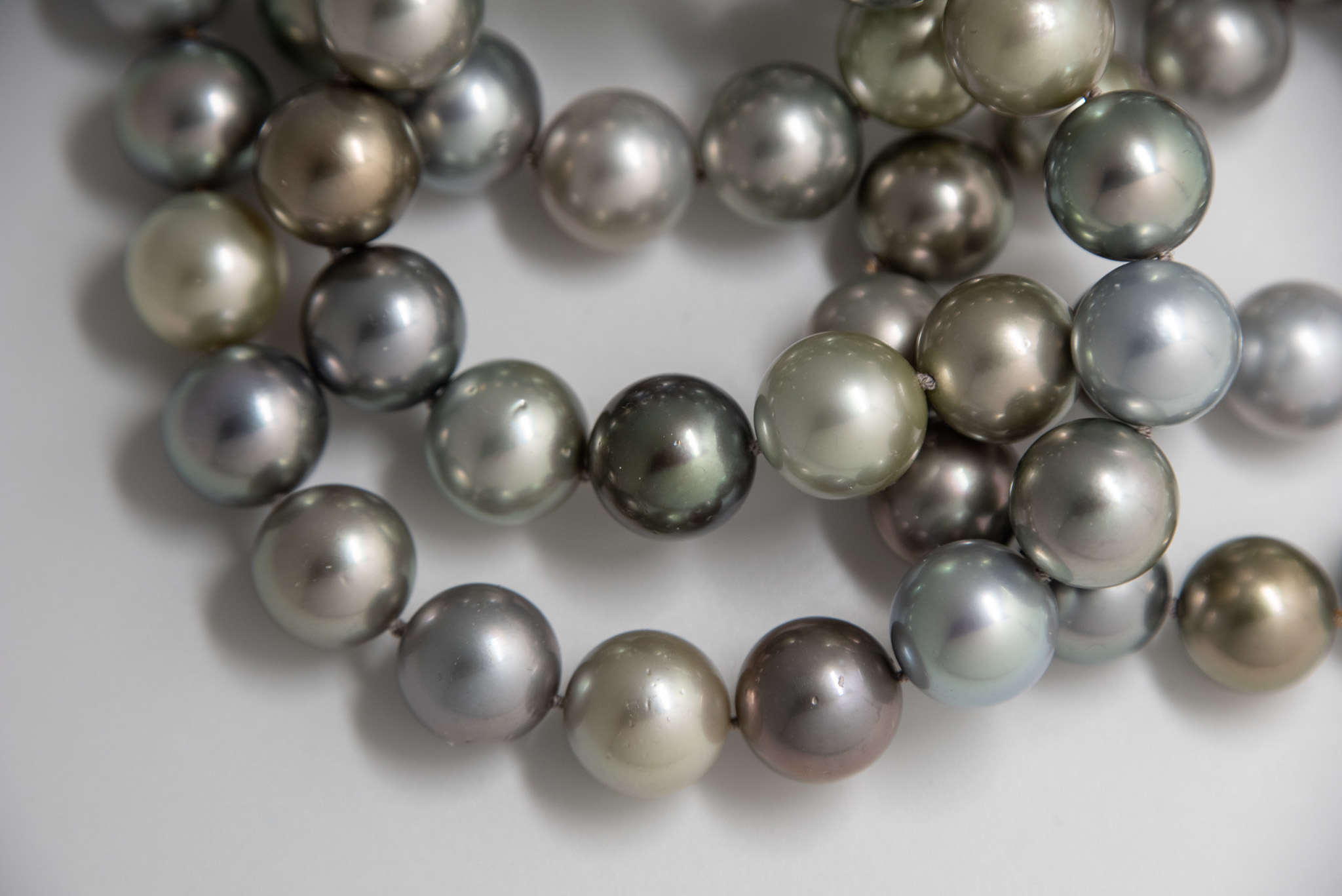 closeup of 12.5mm Tahitian pearls showing hand knotting and color range