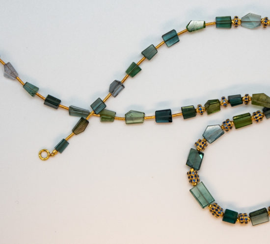 green and blueish tourmaline crystals have been polished in an angular fashion and spaced with 18K gold sapphire rondelles and Turkish 18K gold tube beads